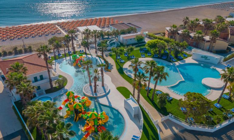 Resort with pools, water slides, and private beach by the sea.